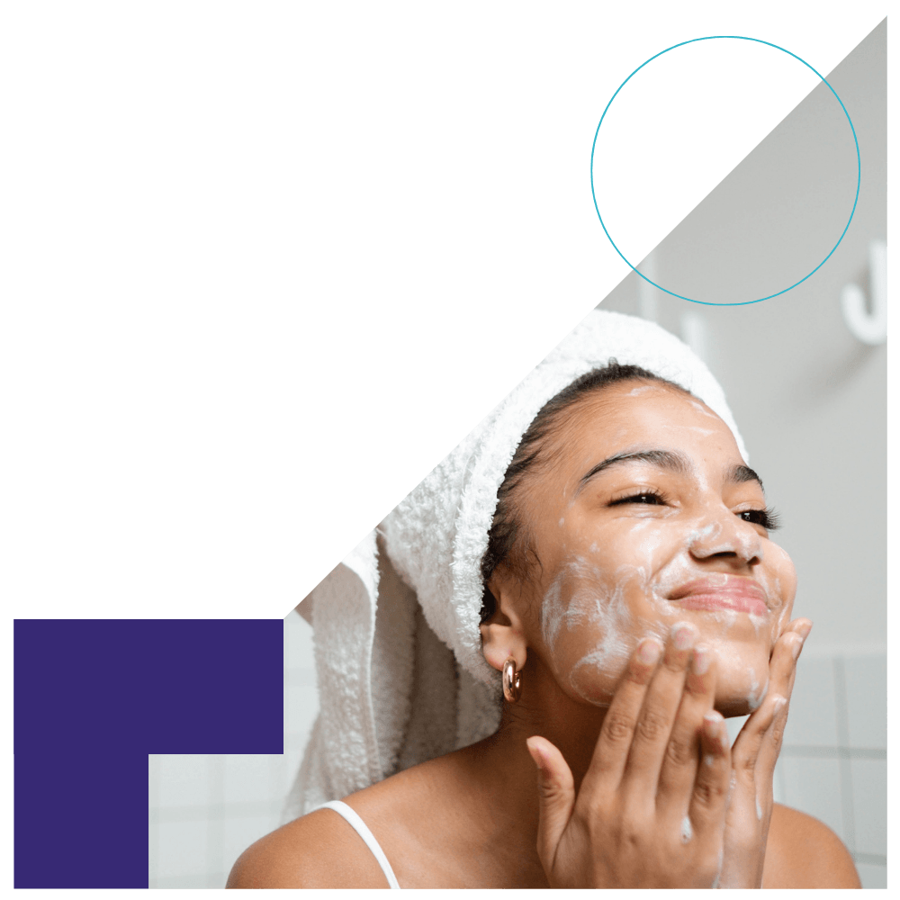 woman washing her face with skincare products